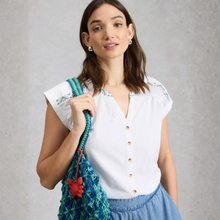 Load image into Gallery viewer, Woman holding a colorful bag against a gray background