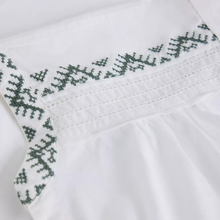 Load image into Gallery viewer, Close-up of white fabric with green embroidery on a white background