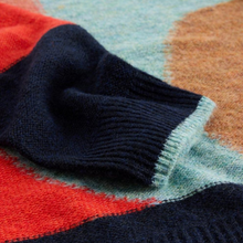 Load image into Gallery viewer, Close-up of a multicolored sweater with red, blue, and green patterns.