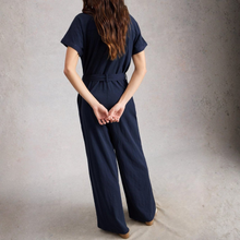 Load image into Gallery viewer, Person wearing a navy blue jumpsuit against a plain background