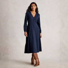 Load image into Gallery viewer, Woman wearing a navy blue dress with long sleeves and brown boots on a plain background