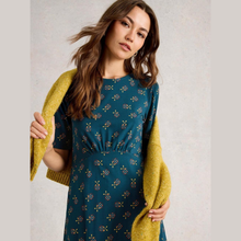 Load image into Gallery viewer, Woman wearing a teal dress with a yellow cardigan against a plain background