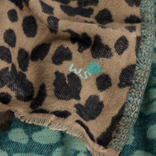 Load image into Gallery viewer, Leopard print fabric with a brand logo on a teal background