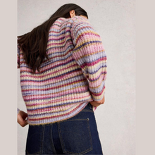 Load image into Gallery viewer, Person wearing a multicolored striped sweater against a plain background
