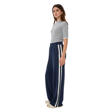 Load image into Gallery viewer, Side view of model wearing Esqualo Wide Stripe Modal Trousers in the colour Navy, with a white background.