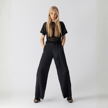 Load image into Gallery viewer, Woman wearing a black outfit with a white background