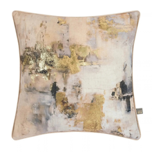 Load image into Gallery viewer, A square decorative throw pillow featuring an abstract watercolor-style print in beige, cream, gold, gray, and black, with a small brand tag on the right edge.