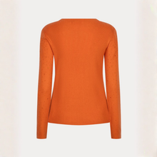 Load image into Gallery viewer, An orange long-sleeve knit sweater shown from the back, featuring subtle textured eyelet details on the sleeves, set against a plain off-white background.
