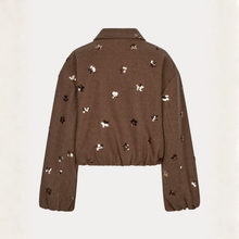 Load image into Gallery viewer, A cropped brown jacket with scattered sequined flowers in gold, silver, and black, displayed against a light off-white background.
