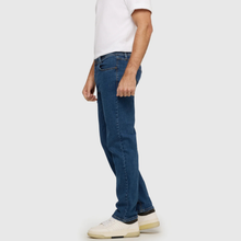 Load image into Gallery viewer, Person wearing blue jeans and a white shirt on a plain background
