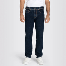 Load image into Gallery viewer, Person wearing dark blue jeans and white sneakers on a white background
