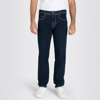 Person wearing dark blue jeans and white sneakers on a white background
