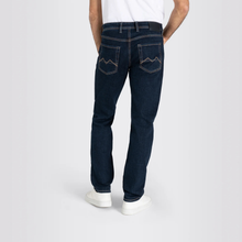 Load image into Gallery viewer, Person wearing dark blue jeans on a white background
