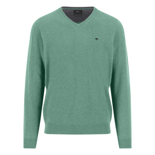 Green sweater with a small logo on a white background