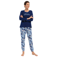 Load image into Gallery viewer, Woman standing with arms crossed wearing navy and floral pyjamas facing toward camera
