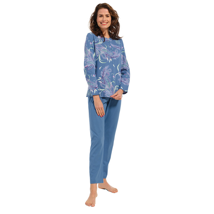 Female model wearing pyjamas with a paisley and peacock feather design on top and blue bottoms facing the camera