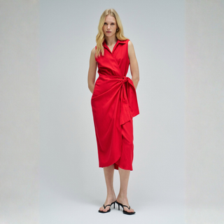 Woman wearing a red dress on a plain background