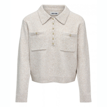 Load image into Gallery viewer, A light beige knit polo sweater with a collar, gold-tone buttons, and two chest pockets with gold button details, shown on a plain white background.

