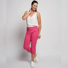 Load image into Gallery viewer, female model wearing pinns cropped trousers in fuschia colour looking away from camera smiling
