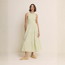 Load image into Gallery viewer, Woman wearing a light green checkered dress against a beige background
