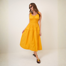 Load image into Gallery viewer, Woman wearing a yellow dress against a white background

