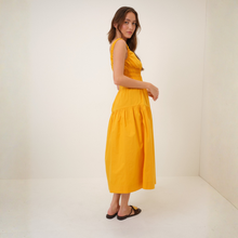 Load image into Gallery viewer, Woman wearing a yellow dress against a white background
