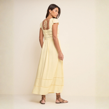 Load image into Gallery viewer, Woman wearing a light yellow dress against a plain background
