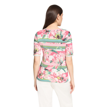 Load image into Gallery viewer, Woman wearing a floral patterned top on a white background
