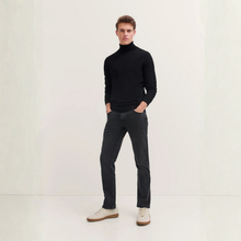 Load image into Gallery viewer, Man wearing a black turtleneck sweater and dark jeans on a white background
