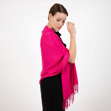 Load image into Gallery viewer, A woman wearing a bright pink shawl over a black outfit, shown from the side against a plain white studio background.
