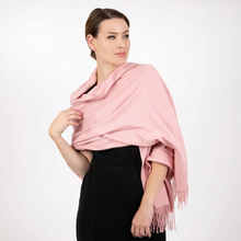 Load image into Gallery viewer, A woman wearing a dusty pink shawl with fringe trim over a black skirt, photographed against a clean white studio background.
