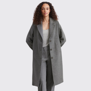 Female model wearing marc opolo wool coat in grey colour with hands behind back