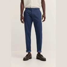 Load image into Gallery viewer, Person wearing navy blue pants with a plain background
