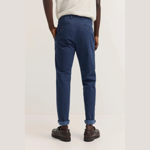 Load image into Gallery viewer, Person wearing blue pants on a plain background
