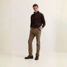 Load image into Gallery viewer, A man modeling a dark brown quarter-zip pullover sweater, olive-brown trousers, and dark brown leather shoes against a light beige studio background.
