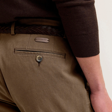 Load image into Gallery viewer, Close-up of a person wearing tan chinos with a brown braided belt and a dark brown ribbed knit sweater, showing the back pocket detail of the trousers.
