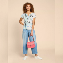 Load image into Gallery viewer, female model looking at camera holding handbag wearing whitestuff nelly neck tee in white colour
