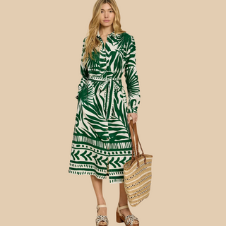 female model looking at camera wearing whitestuff dress in green print colour