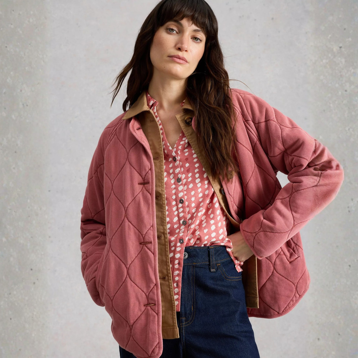 Load image into Gallery viewer, Woman wearing a pink quilted jacket over a polka dot shirt against a gray background