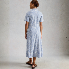 Load image into Gallery viewer, Woman wearing a blue patterned dress against a gray background
