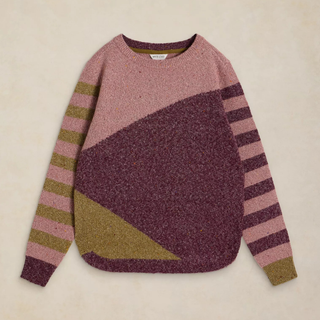 A color-blocked knit sweater with a dusty pink upper chest, a large dark plum-purple geometric panel across the front, olive green stripe details on the sleeves, and a matching olive green triangular accent near the lower front, laid flat on a light beige background.