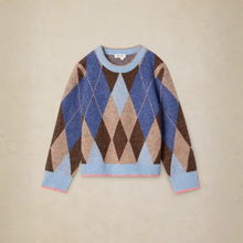 Load image into Gallery viewer, A long-sleeve crewneck sweater with an argyle diamond pattern in shades of blue, brown, beige, and light blue, featuring light blue ribbed cuffs and hem, laid flat on a beige background.
