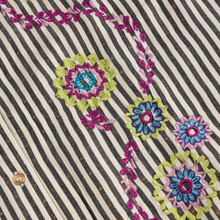 Load image into Gallery viewer, Close-up of a striped fabric with vertical black and off-white stripes, decorated with colorful floral embroidery in pink, blue, green, and purple, and a small wooden button visible near the lower left.
