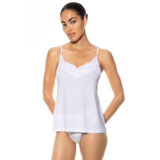 Woman wearing a white camisole against a white background