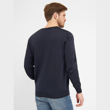 Load image into Gallery viewer, Man wearing a navy blue sweater and light blue jeans on a white background
