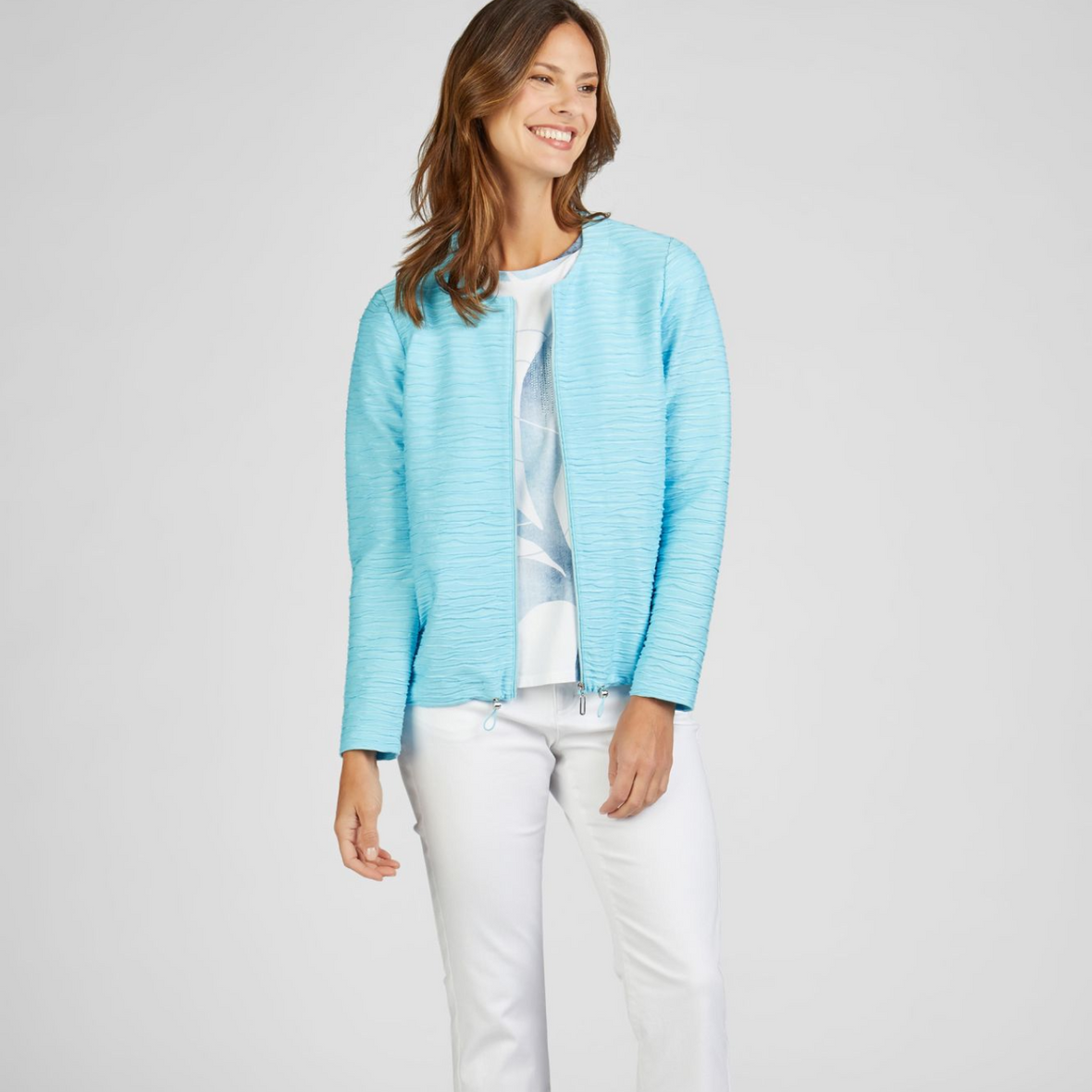 female model looking away from camera smiling wearing rabe jacket in blue colour