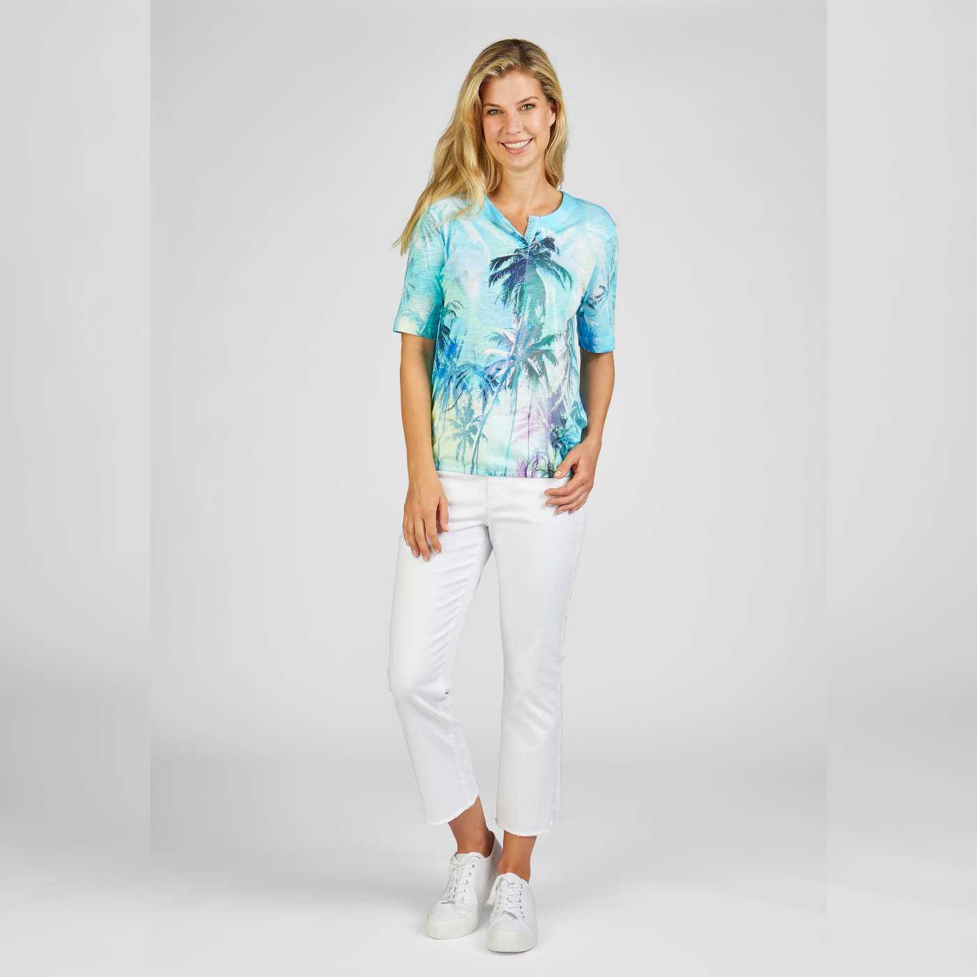 Model standing wearing Rabe Palmtree print T-Shirt in aqua color.