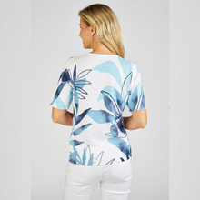 Load image into Gallery viewer, Model showing back of Rabe Leaf Print knitted top in white and blue colors.

