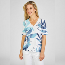 Load image into Gallery viewer, Model wearing Rabe knitted v-neck short sleeve top with large leaf print.
