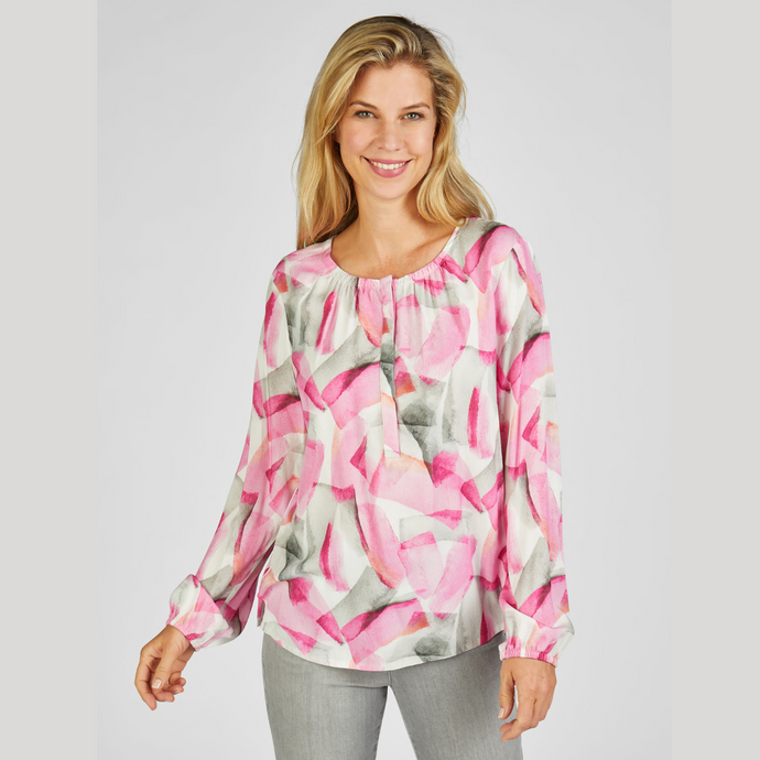 female model smiling looking at camera wearing rabe abstract top in pink & grey colour
